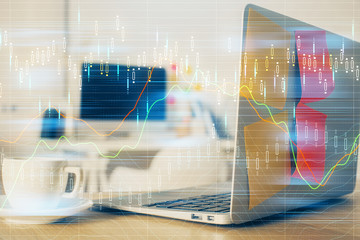 Financial graph colorful drawing and table with computer on background. Double exposure. Concept of international markets.