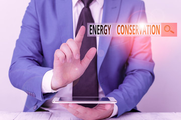 Conceptual hand writing showing Energy Conservation. Concept meaning Reduction in the amount of...