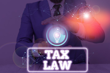 Conceptual hand writing showing Tax Law. Concept meaning governmental assessment upon property...