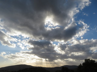 sunlight among clouds over mountains