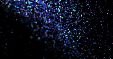 Flying dust particles on a black background