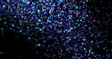 Flying dust particles on a black background