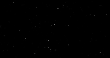Flying dust particles on a black background