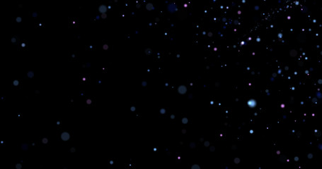 Flying dust particles on a black background