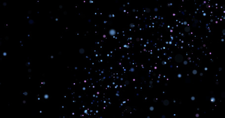 Flying dust particles on a black background