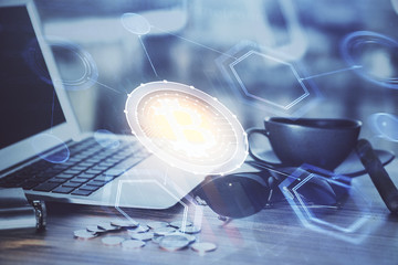 Double exposure of blockchain theme hologram and table with computer background. Concept of bitcoin crypto currency.