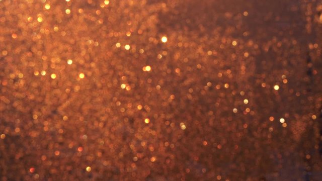 Beautiful Defocused Bokeh on Frosty Window Glittering in Golden Rising Sun. Ice Crystals Hoarfrost on Glass Window Sparkling at Winter Sunrise