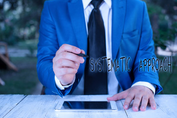 Text sign showing Systematic Approach. Business photo text A process used to determine the viability of a project Businessman holds pen and points into copy space