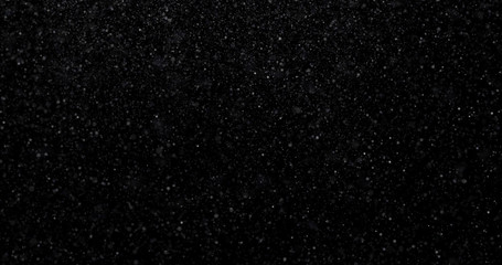 Natural white winter snowfall on a black background