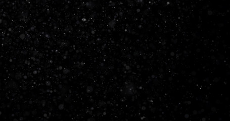 Natural white winter snowfall on a black background
