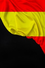 vertical colored national flag of modern state of Spain, beautiful silk, black blank, concept of tourism, economy, politics, emigration, independence day, copy space, template