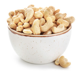 Bowl with cashew nuts on white background