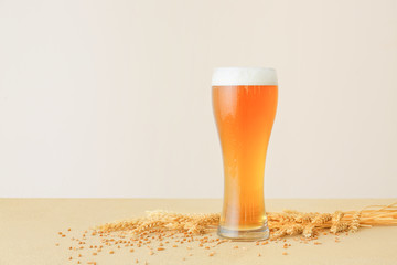 Glass of fresh beer on table