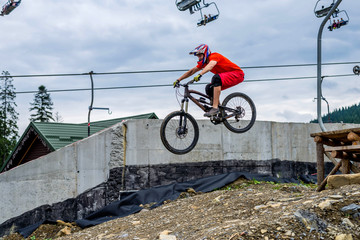 Extreme cyclist jumping from a springboard on a mountain bike. MTB.