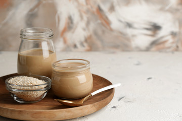 Jars of tasty tahini on table