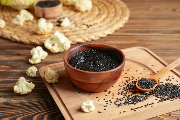 Bowl of tasty tahini on wooden table
