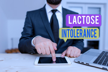 Word writing text Lactose Intolerance. Business photo showcasing digestive problem where body is unable to digest lactose Male human wear formal clothes present presentation use hi tech smartphone