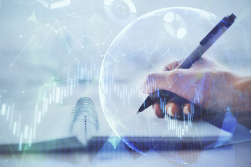Forex graph on hand taking notes background. Concept of research. Multi exposure