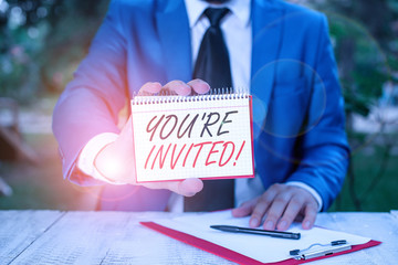 Conceptual hand writing showing You Re Invited. Concept meaning make a polite friendly request to...