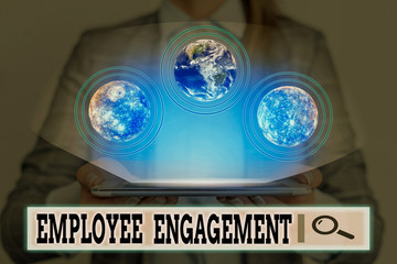 Writing note showing Employee Engagement. Business concept for relationship between an organization and its employees Elements of this image furnished by NASA