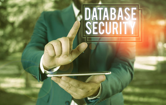 Text sign showing Database Security. Business photo text security controls to protect databases against compromises Businessman in blue suite with a tie holds lap top in hands
