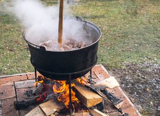 Romanian traditional food prepared at the cauldron on the open fire with wood, Christmas tradition