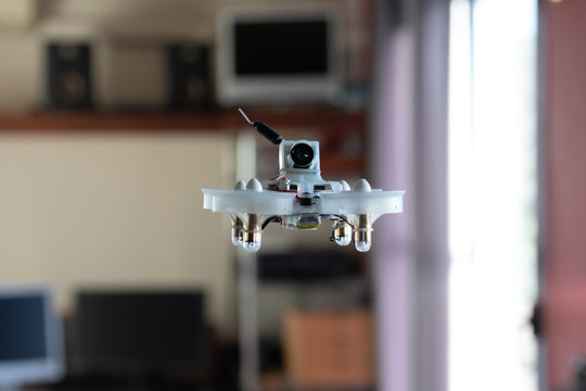 Micro Spy Drone Flying Inside A House. Remote Controlled Nano Air Vehicle With A Small Camera.