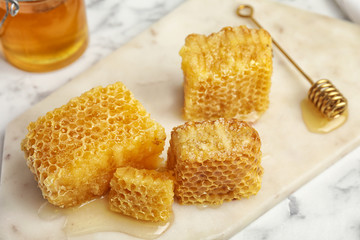 Fresh delicious sweet honeycombs on white board