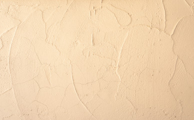 Cream and beige pastel color of rough surface mortar concrete wall with random texture cement plaster masory man's work