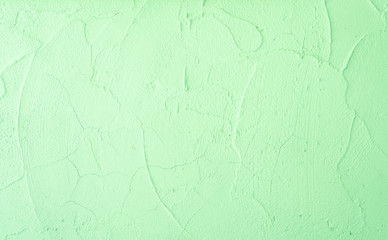 Green pastel color of rough surface mortar concrete wall with random texture cement plaster masory man's work