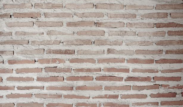 Rough horizontal line of natural lighter brown color clay brick in motar concrete structure wall background