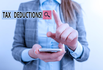 Word writing text Tax Deductions. Business photo showcasing reduction income that is able to be taxed of expenses Business concept with mobile phone and business woman