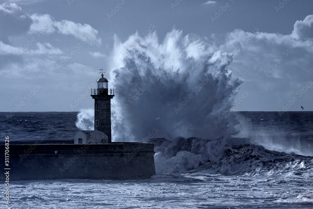 Sticker Stormy waves splash over lighthouse