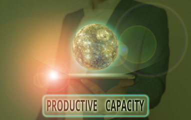 Word writing text Productive Capacity. Business photo showcasing the maximum possible output of a production plant Elements of this image furnished by NASA