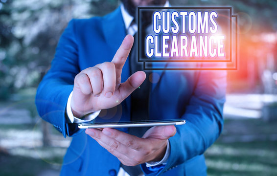 Text sign showing Customs Clearance. Business photo text documentations required to facilitate export or imports Businessman in blue suite with a tie holds lap top in hands