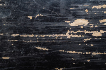 Scratched wood texture with black paint close up. rough wooden background