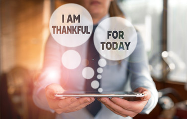 Conceptual hand writing showing I Am Thankful For Today. Concept meaning Grateful about living one more day Philosophy Woman in the background pointing with finger in empty space