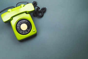 Classic phone with handset. vintage green telephone with phone receiver isolated on color...