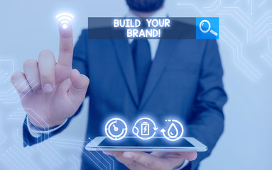 Writing note showing Build Your Brand. Business concept for creates or improves customers knowledge and opinions of product