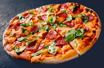 Foto op Canvas Pepperoni Pizza with Mozzarella cheese, salami, Tomato sauce, pepper, Spices and Fresh arugula. Italian pizza on Dark grey black slate background © pavel siamionov