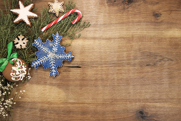 Christmas background with blue snowflake and spruce branches.