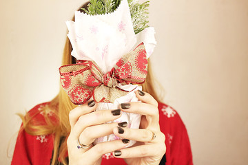 Girl holding a gift with a bow.
