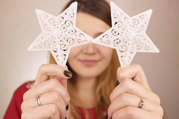 A young girl holds two stars in her hands.