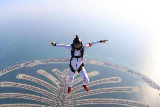 Risk. Brave men in parachute equipment. Skydiving is sport for extreme people. Flyer in white suit. The sky without borders.