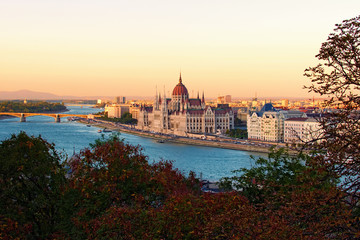 Aerial landscape view of Budapest. Picturesque Danube River and The Hungarian Parliament Building during sunset. Autumn colors in the background. Budapest, Hungary
