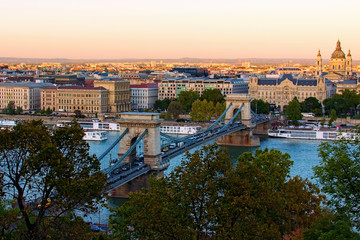 Fototapeta na wymiar Beautiful landscape photo of ancient Budapest. One of the main attractions are the Chain Bridge over Danube River and Basilica of Saint Stephen. Travel and tourism concept. Budapest, Hungary