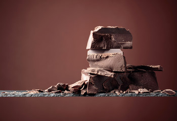Black chocolate on a brown background.