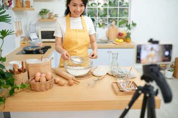 Young asian woman recording video for her blog