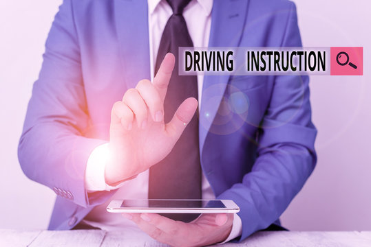 Conceptual hand writing showing Driving Instruction. Concept meaning detailed information on how driving should be done Businessman with pointing finger in front of him