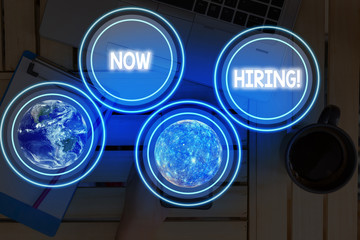 Word writing text Now Hiring. Business photo showcasing finding evaluating working relationship with future employees Elements of this image furnished by NASA